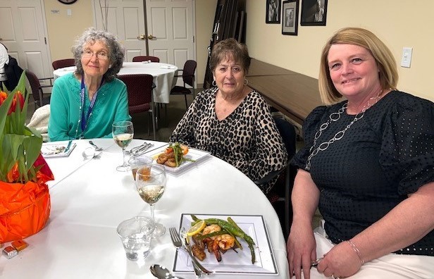 Pictured from the left are volunteers Louise Cody, Diane Poplowski and Executive Director of Arbor Rose, Lori Toombs enjoying the main course of the dinner. 